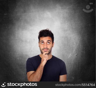 Pensive young men in black over a irregular gray background