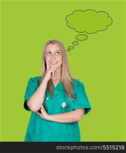 Pensively doctor girl smiling on a green background