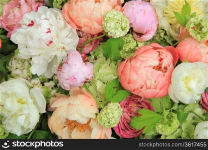 Peonies in various shades of pink and white in a floral wedding arrangement