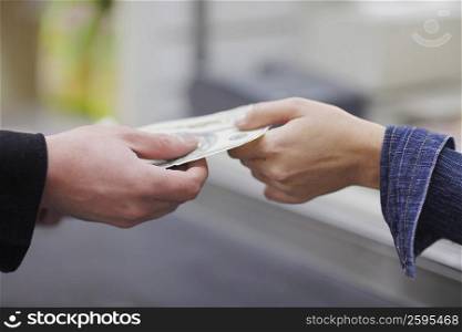 People&acute;s hands exchanging paper currency