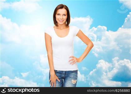 people, advertisement and clothing concept - happy woman in blank white t-shirt over blue sky with white clouds background
