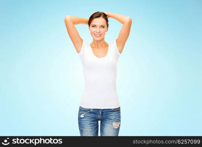 people, advertisement and clothing concept - happy woman in blank white t-shirt over blue background