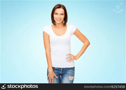 people, advertisement and clothing concept - happy woman in blank white t-shirt over blue background