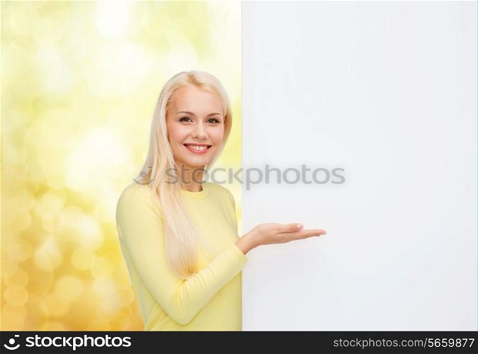 people, advertisement and sale concept - happy woman in sweater with blank white board