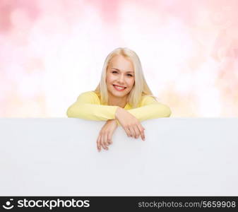 people, advertisement and sale concept - happy woman in sweater with blank white board