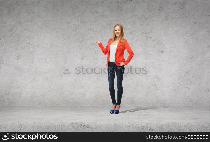 people, advertising and happiness concept - beautiful teenage girl in casual clothes on high heels holding something on her palm