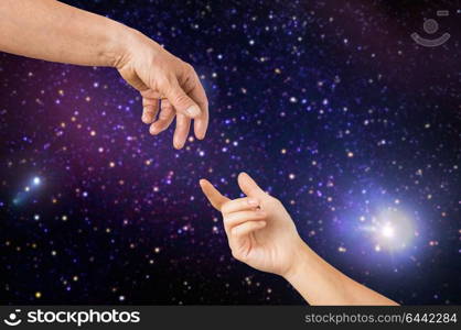 people, age and body parts concept - close up of senior and young woman hands reaching to each other over space background. close up of senior and young woman hands in space