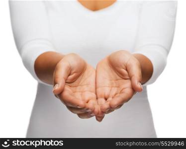 people and advertisement concept - close up of womans cupped hands showing something