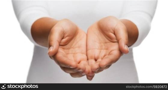 people and advertisement concept - close up of womans cupped hands showing something. womans cupped hands showing something