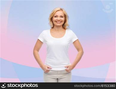 people and advertisement concept - smiling woman in blank white t-shirt over pink and violet background. smiling woman in blank white t-shirt