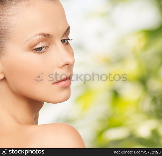 people and beauty concept - beautiful young woman over green background