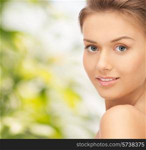 people and beauty concept - beautiful young woman over green background