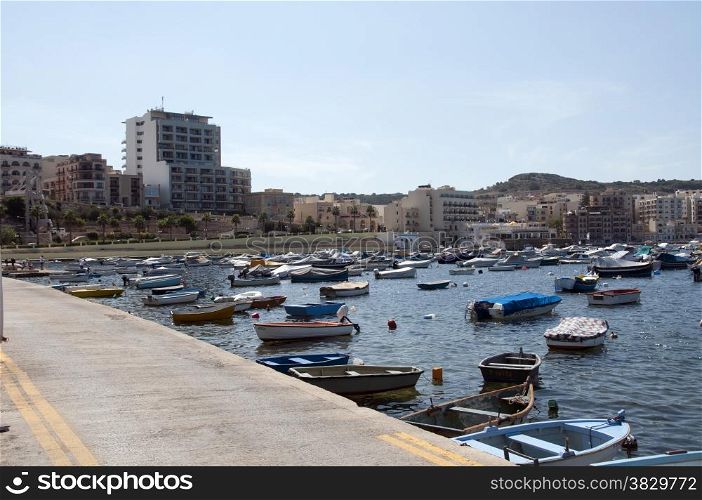 people and boats in the harbour of Bugibba on Malta