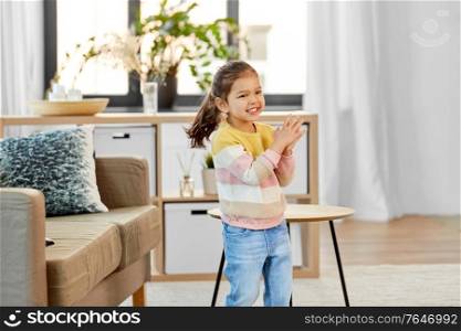 people and childhood concept - happy smiling little girl at home. happy smiling little girl at home