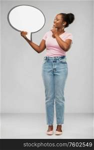 people and communication concept - happy african american young woman holding big blank speech bubble over grey background. happy african american woman holding speech bubble