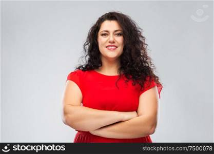 people and confidence concept - happy woman in red dress with crossed arms over grey background. happy confident woman in red with crossed arms