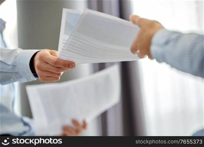 people and corporate concept - close up of business team with papers at office. close up of business team with papers at office