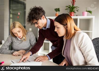 people and corporate concept - happy business team with papers meeting in office. happy business team with papers in office