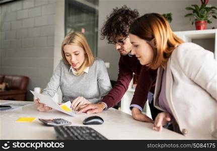 people and corporate concept - happy business team with papers meeting in office. happy business team with papers in office. happy business team with papers in office