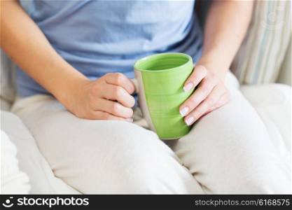 people and drinks concept - close up of young woman with tea cup. close up of young woman with tea cup