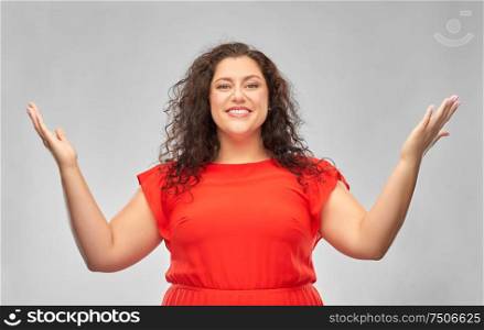 people and emotion concept - happy amazed woman in red dress looking up over grey background. happy smiling woman in red dress looking up