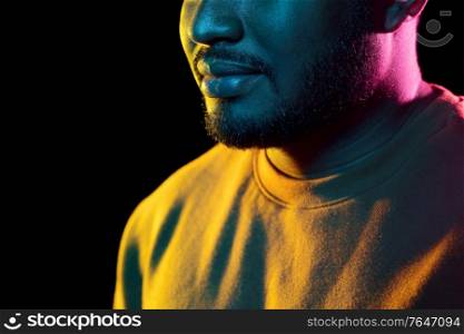 people and ethnicity concept - close up of young african american man over black background. young african american man over black background