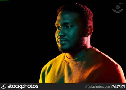 people and ethnicity concept - portrait of young african american man over black background. young african american man over black background