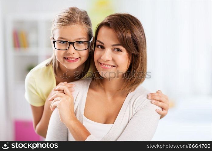 people and family concept - portrait of happy mother and daughter at home. portrait of happy mother and daughter at home