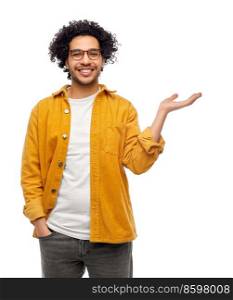 people and fashion concept - happy smiling man in glasses and yellow jacket holding something on his hand over white background. happy man in glasses holding something on his hand