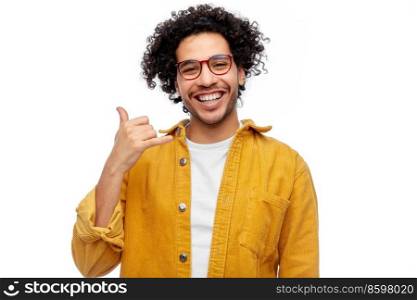 people and fashion concept - happy smiling man in glasses and yellow jacket making phone call gesture over white background. happy man in glasses making phone call gesture