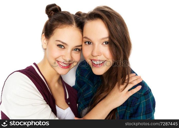people and friendship concept - happy smiling pretty teenage girls hugging over white background. happy smiling pretty teenage girls hugging