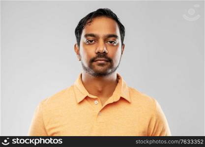 people and furniture concept - portrait of young indian man over grey background. portrait of young indian man