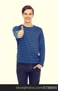 people and happiness concept - smiling teenage boy over white background showing thumbs up