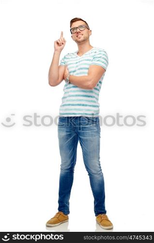 people and idea concept - happy young woman pointing finger up over white. happy young man pointing finger up
