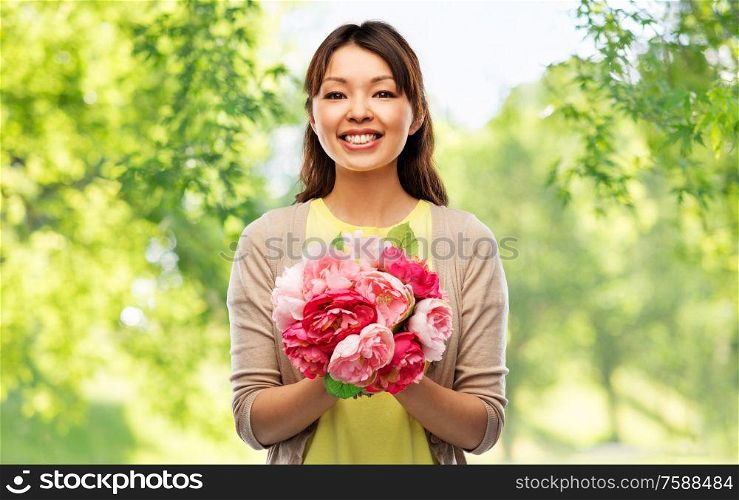people and international women&rsquo;s day concept - happy asian young woman with bunch of peony flowers over green natural background. happy asian woman with bunch of flowers