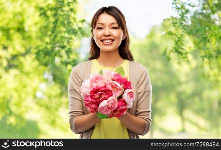 people and international women&rsquo;s day concept - happy asian young woman with bunch of peony flowers over green natural background. happy asian woman with bunch of flowers