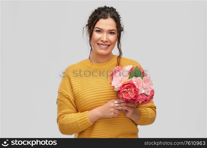 people and international women&rsquo;s day concept - portrait of happy smiling young woman with pierced nose with bunch of peony flowers over grey background. happy smiling young woman with bunch of flowers