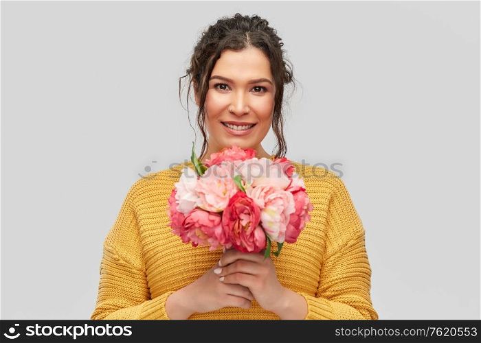 people and international women&rsquo;s day concept - portrait of happy smiling young woman with pierced nose with bunch of peony flowers over grey background. happy smiling young woman with bunch of flowers