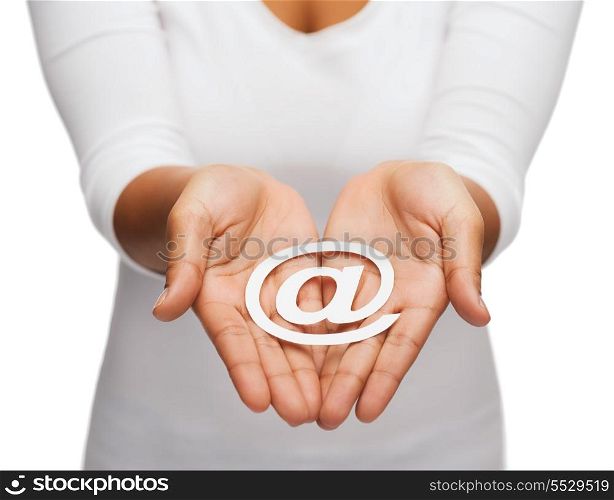 people and internet concept - closeup of womans cupped hands showing e-mail cutout sign