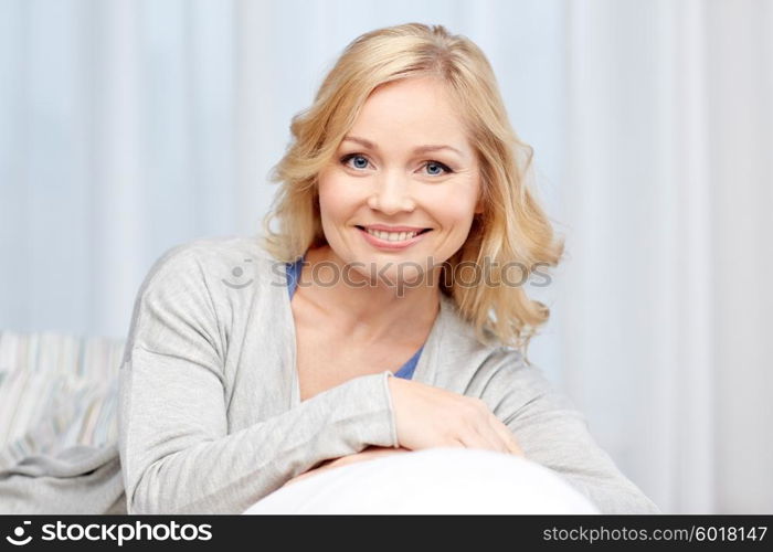 people and leisure concept - happy middle aged woman at home. happy middle aged woman at home