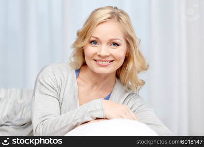 people and leisure concept - happy middle aged woman at home. happy middle aged woman at home