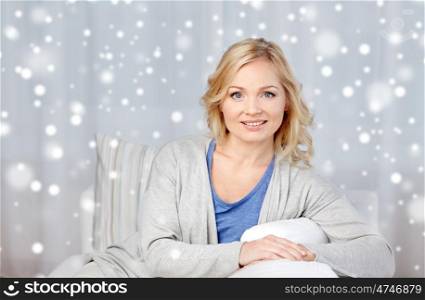 people and leisure concept - happy middle aged woman at home over snow. happy middle aged woman at home