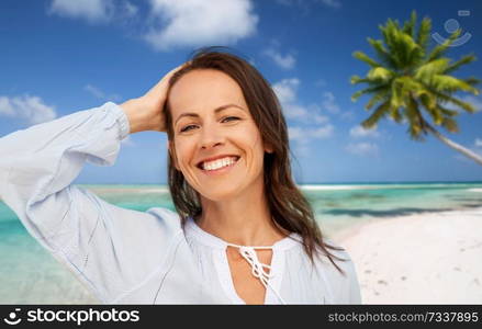 people and leisure concept - happy smiling woman over tropical beach background in french polynesia. happy smiling woman on summer beach