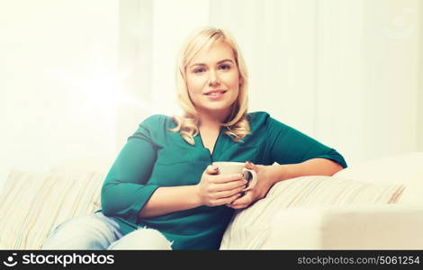 people and leisure concept - happy woman with cup of tea or coffee at home. happy woman with cup of tea or coffee at home