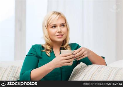 people and leisure concept - happy woman with cup of tea or coffee at home. happy woman with cup of tea or coffee at home