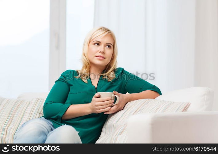 people and leisure concept - happy woman with cup of tea or coffee at home. happy woman with cup of tea or coffee at home