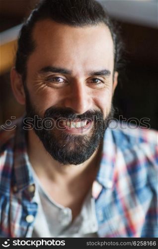 people and men concept - happy young man with beard and mustache in checkered shirt. happy young man with beard and mustache