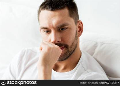 people and mood concept - close up of man in bed thinking. close up of man in bed thinking