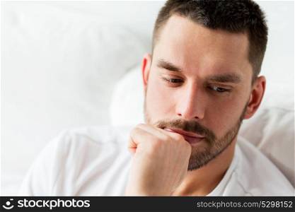 people and mood concept - close up of man in bed thinking. close up of man in bed thinking