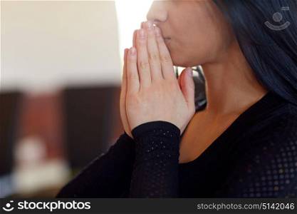 people and mourning concept - close up of unhappy woman praying god at funeral in church. close up of sad woman praying god in church